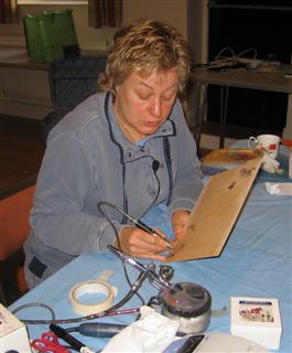 Joey piercing a design onto a board